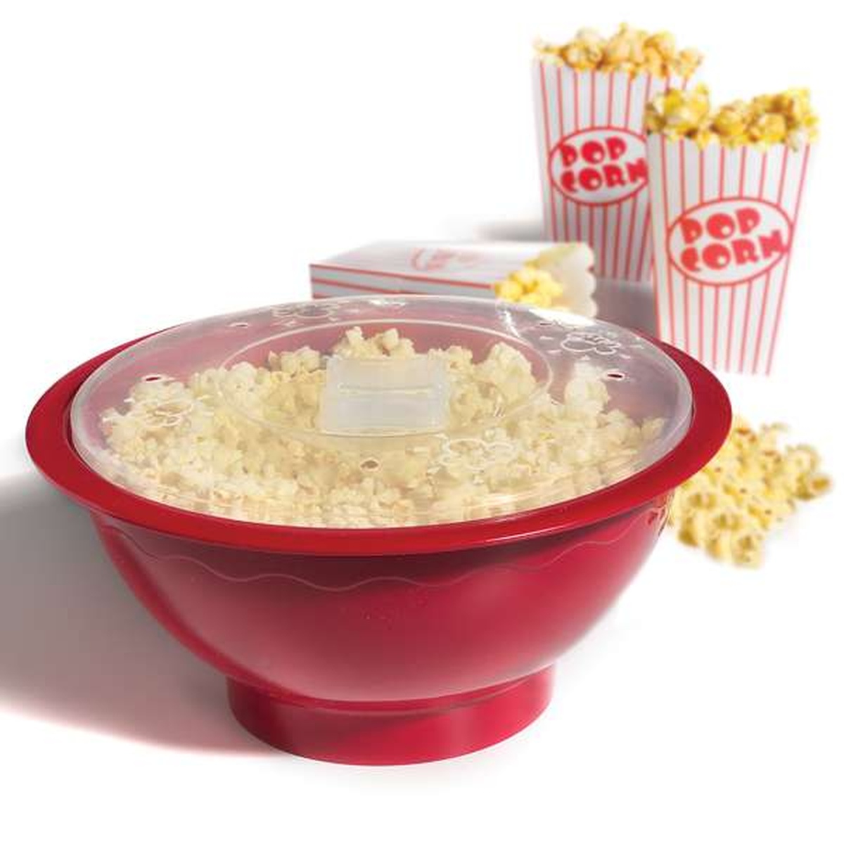 Norpro Microwave Popcorn Popper red bowl filled with popcorn under clear lid with popcorn boxes in background