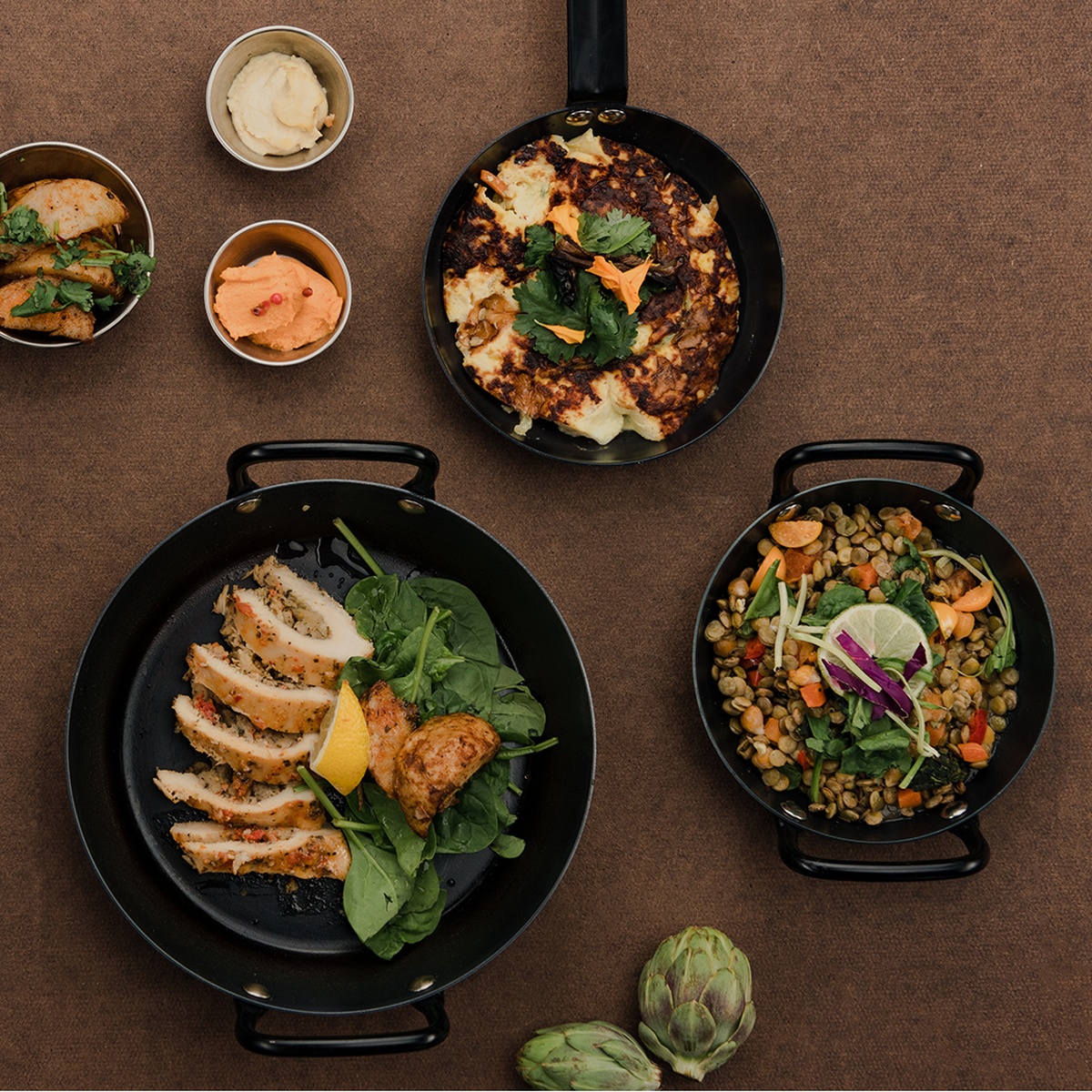 Browne Thermalloy carbon steel fry pans used for serving various dishes on a tabletop