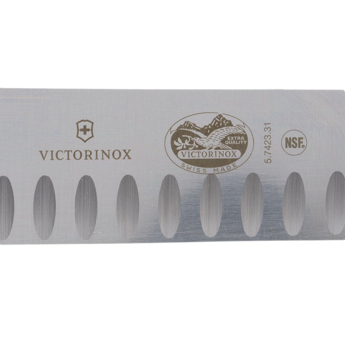 Close-up of Victorinox butcher knife blade showing the Victorinox Swiss Made Extra Quality stamp, model number 5.7423.31, and NSF certification mark alongside Granton edge scallops