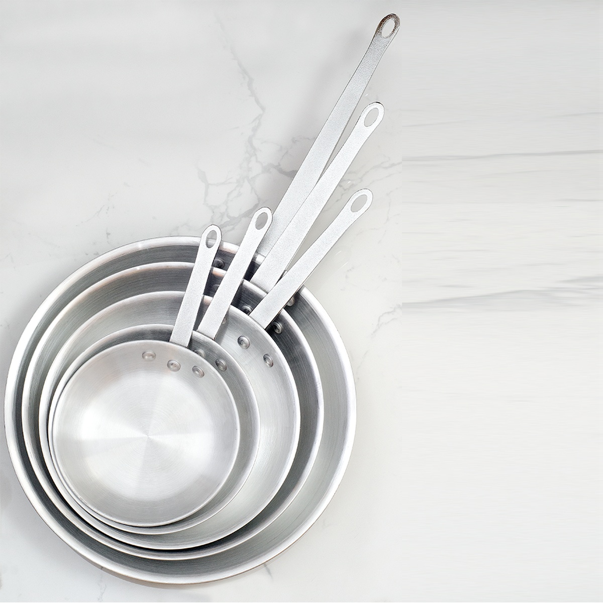 Top down view of nested Thermalloy aluminum frying pans