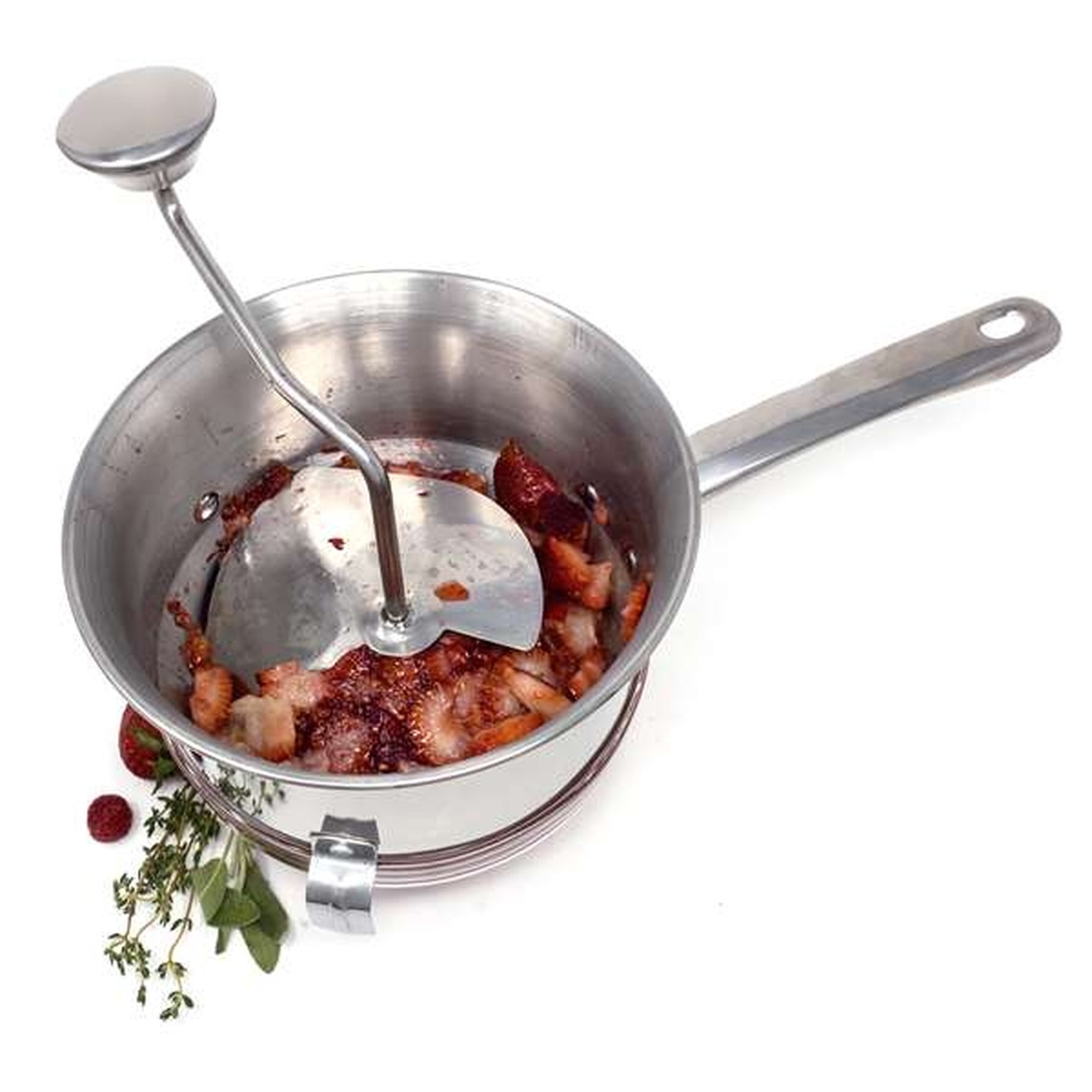 Food mill in use with crushed fruit and herbs