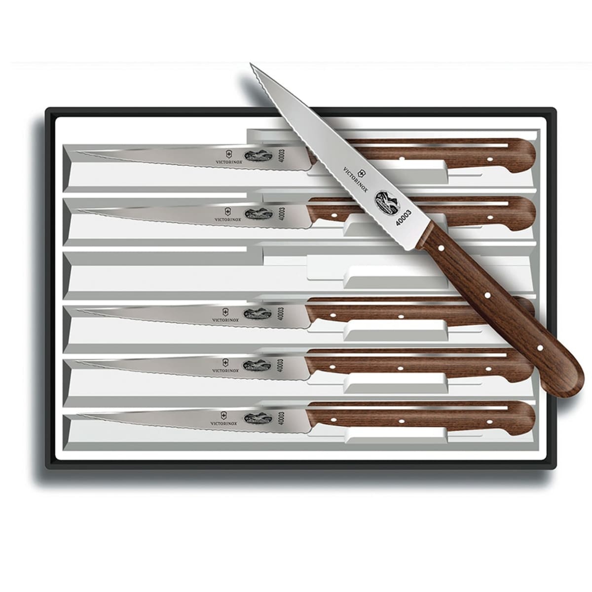 Victorinox 6-piece steak knife set displayed in tray, one knife angled on top showing serrated blade and rosewood handle