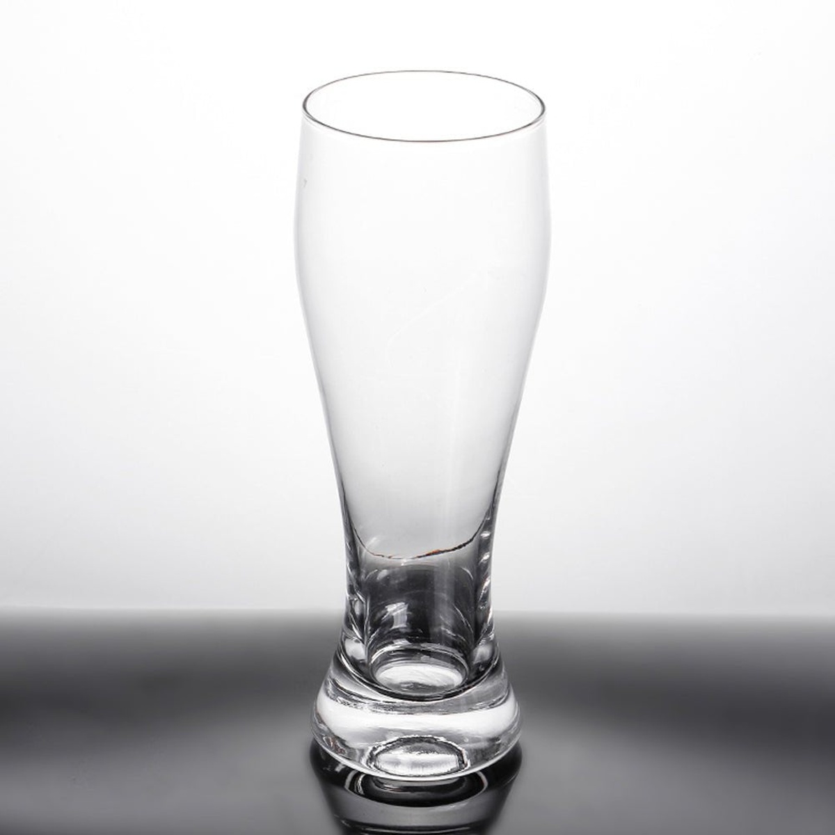 Enhanced pilsner glass on neutral background showing full tapered silhouette and thick base