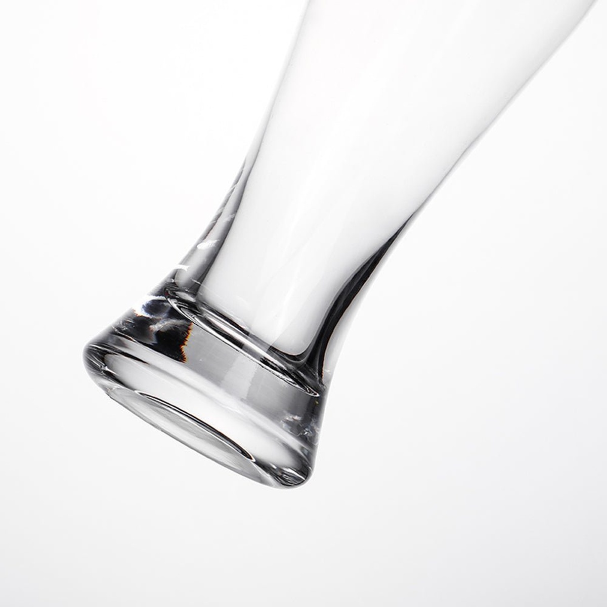 Close-up detail of the weighted base of the Enhanced pilsner glass showing thick solid glass construction