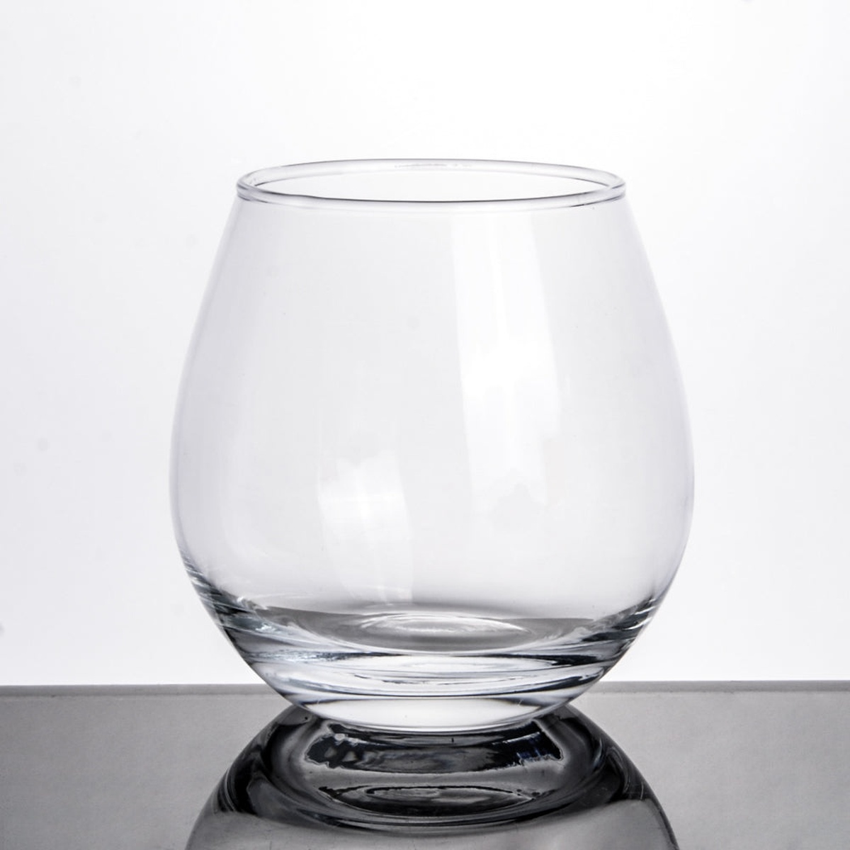 Enhanced Glassware 6LB04 19 oz clear stemless wine glass, rounded bowl shape on a gray surface