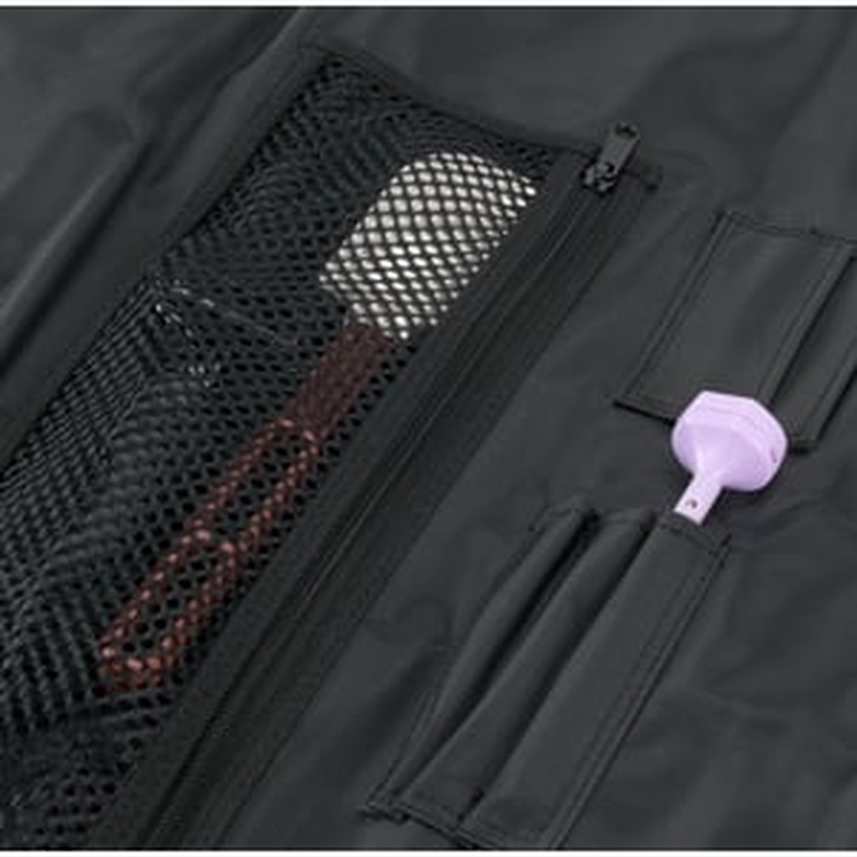 Close-up of interior mesh zip pocket and accessory sleeves inside the knife roll