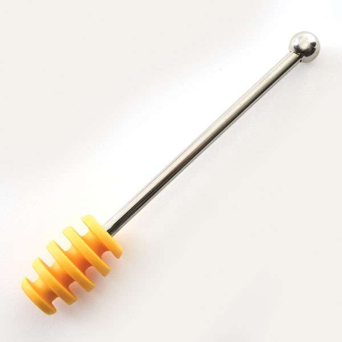 Norpro Silicone Honey Dipper with yellow silicone head and stainless steel handle on light background