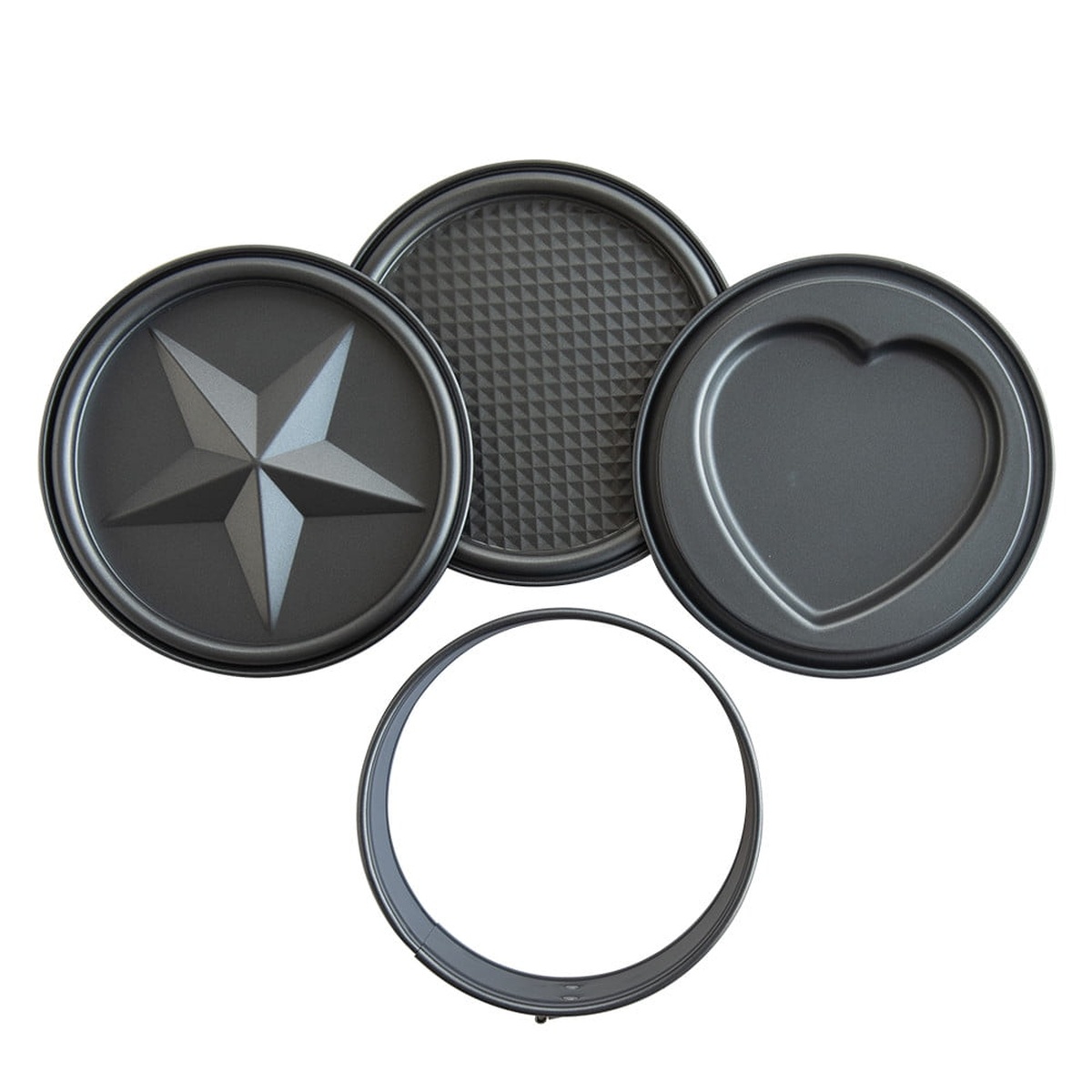 All four components of the Nordic Ware springform set laid flat: three decorative discs with star, diamond-grid, and heart patterns, plus the springform collar ring