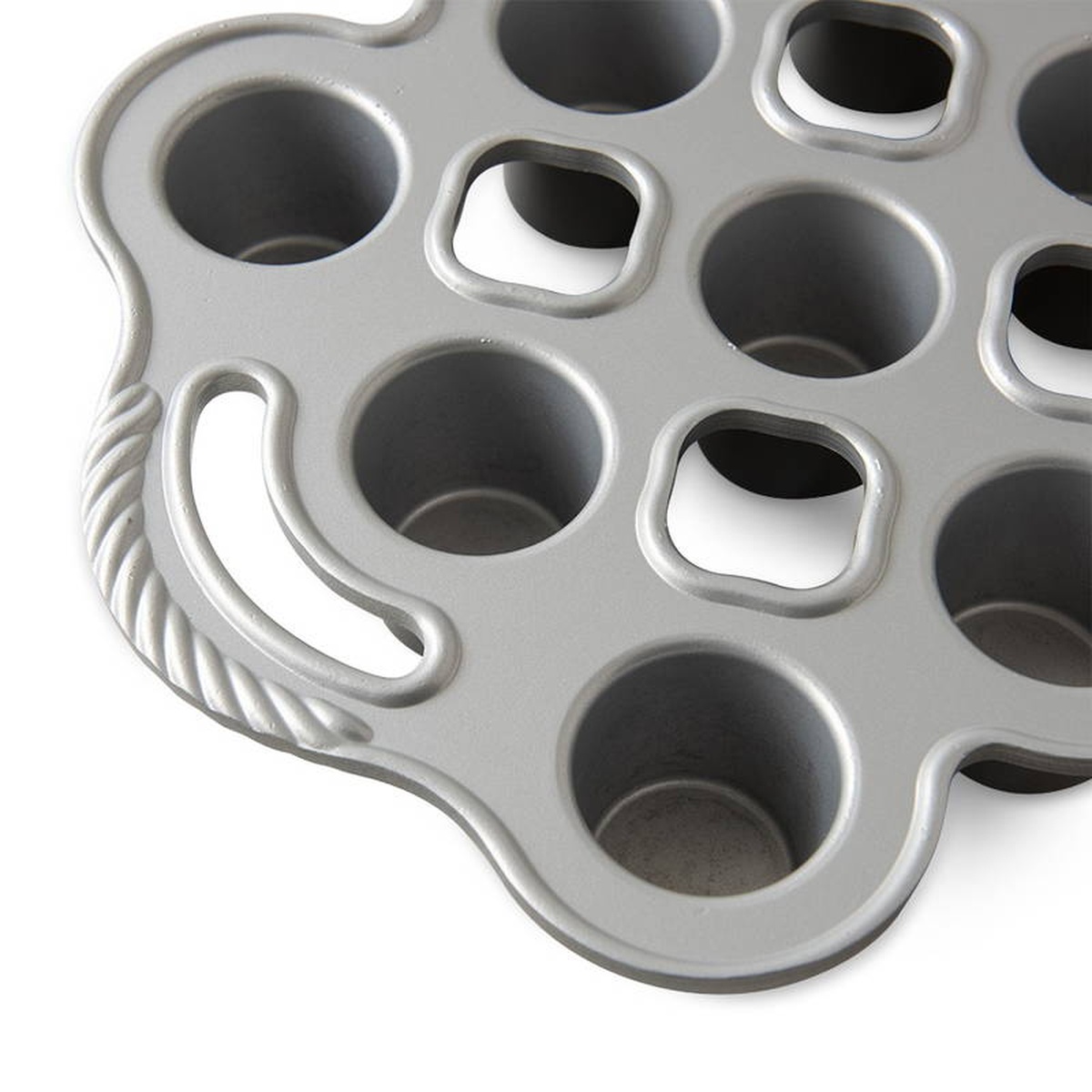 Close-up detail of Nordic Ware popover pan showing deep cylindrical cups, non-stick interior, and decorative rope-detail handle