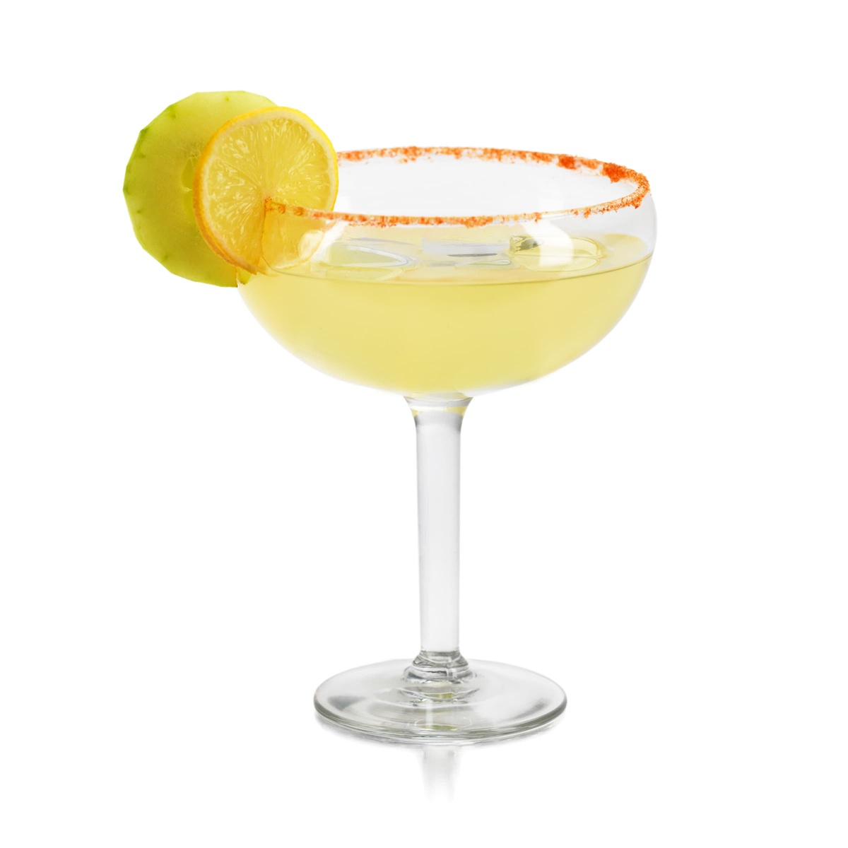Libbey 8417 Fiesta Grande glass filled with a yellow cocktail and garnished with citrus slices and a spiced rim on white background