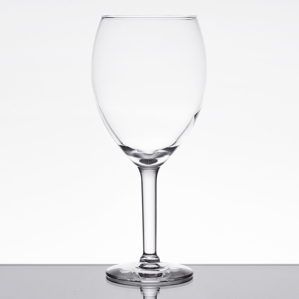 Libbey 8420 Vino Grande 19.5 oz. stemmed wine glass, clear glass with long stem and wide foot, on a reflective surface