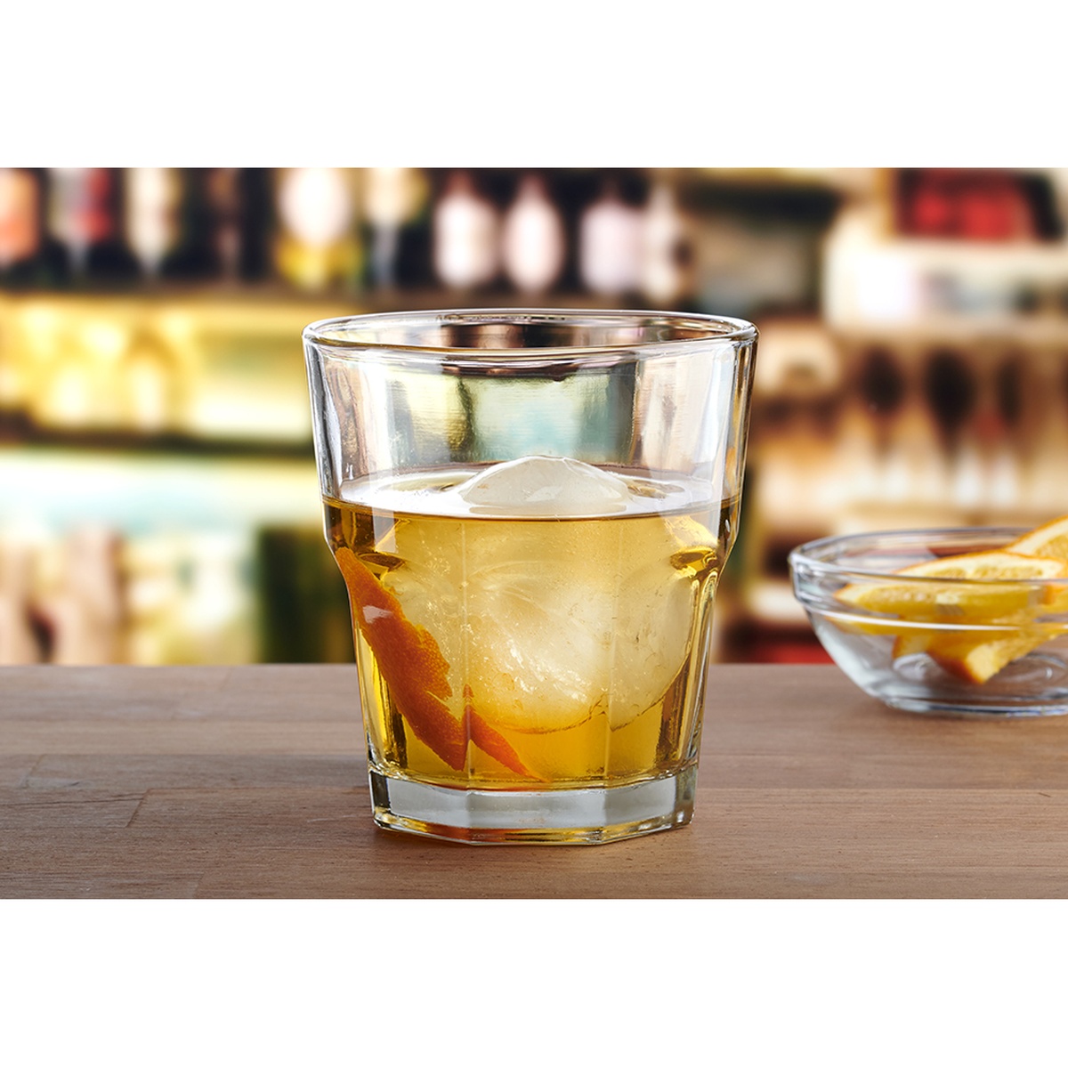 Anchor Hocking 90010 New Orleans 12 oz Double Rocks Glass filled with whiskey and a large ice sphere