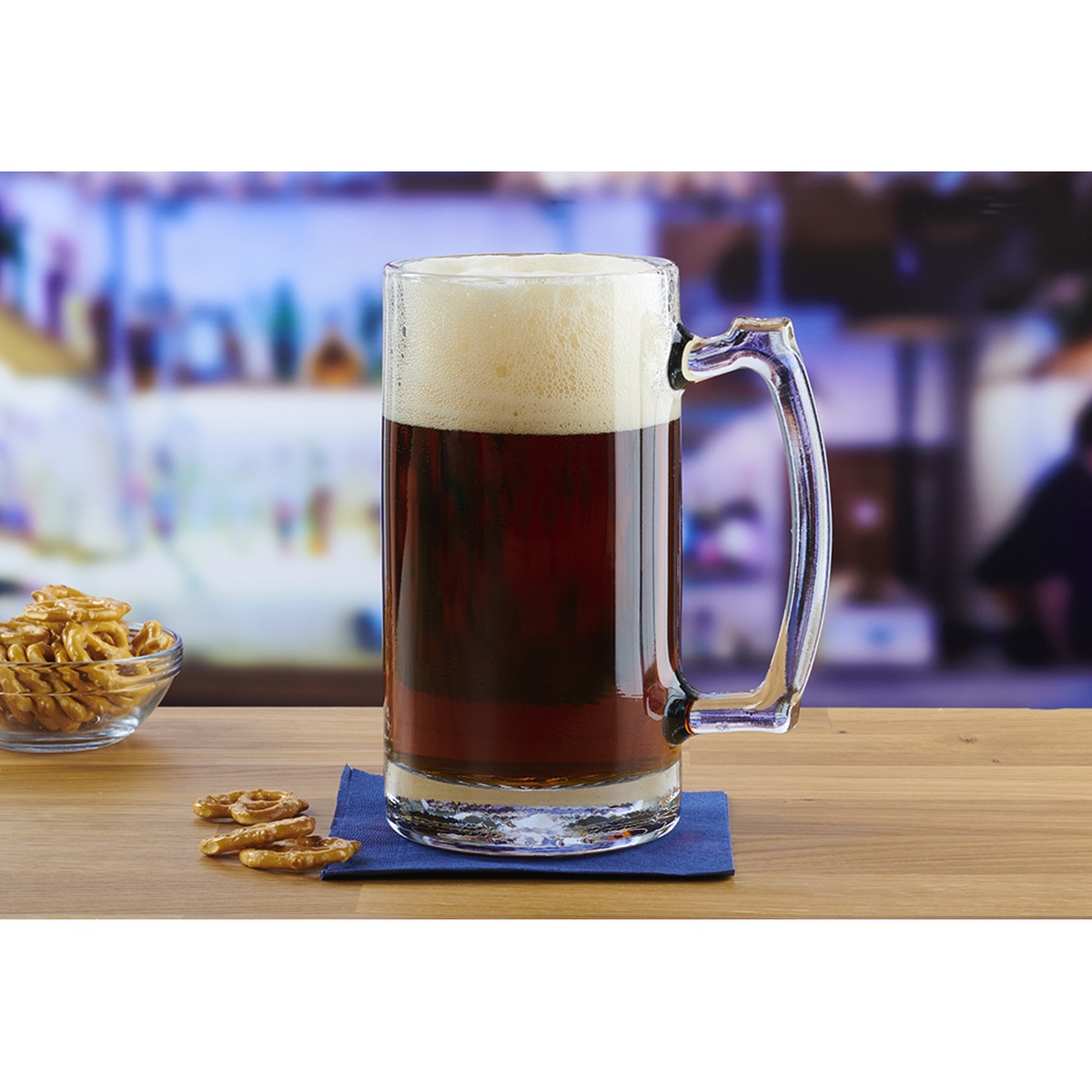 Anchor Hocking 90272 Champions 25 oz clear glass beer mug filled with dark beer and foam head, large handle visible