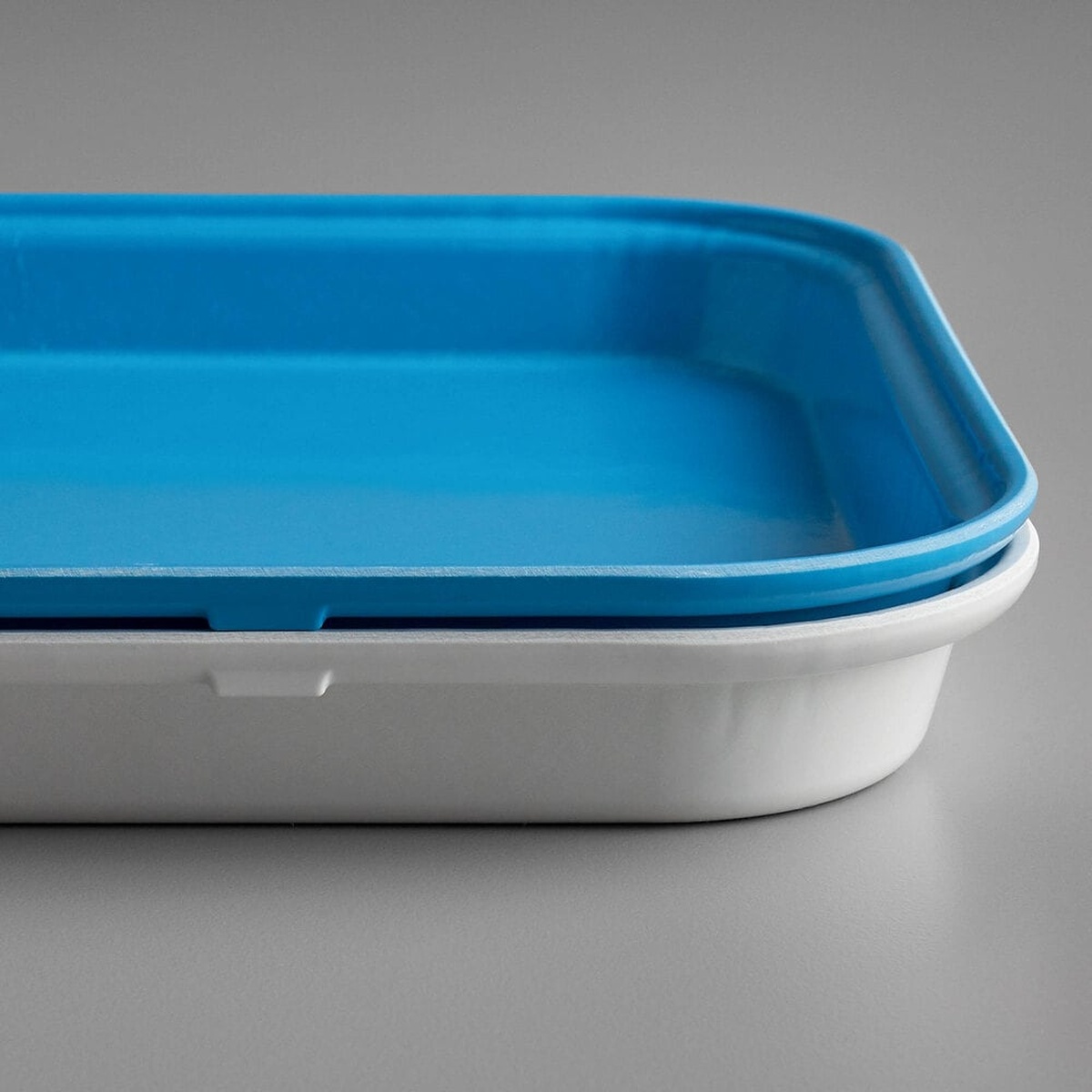 Close-up of Cambro white and blue market trays stacked together, showing Dri-Stak lug separators