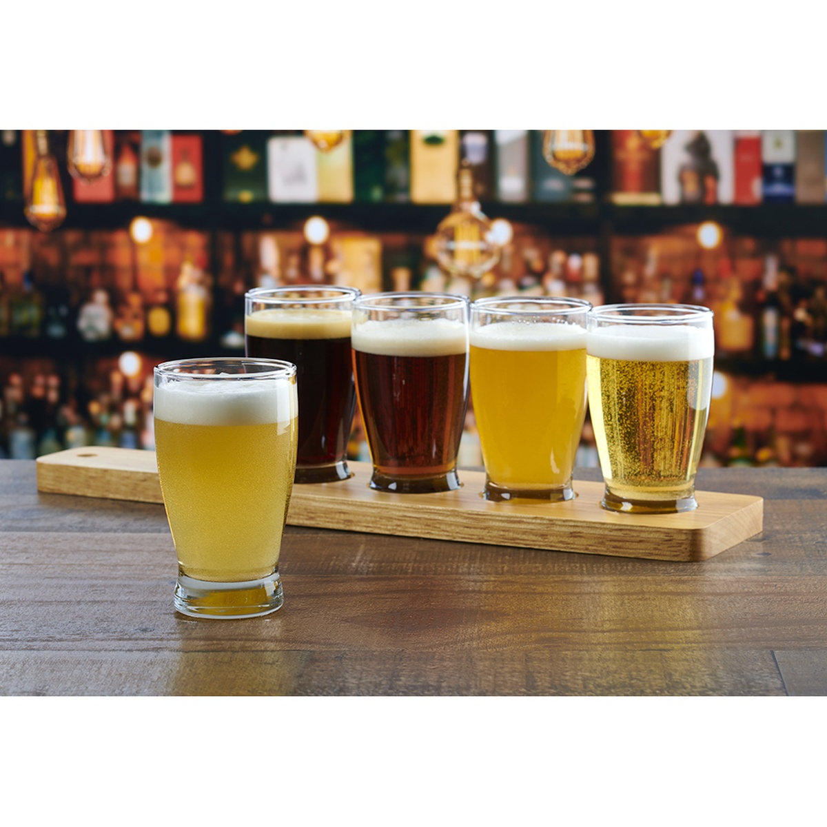 Anchor Hocking Barbary 5 oz. beer flight taster glasses filled with various craft beers on a wooden serving paddle