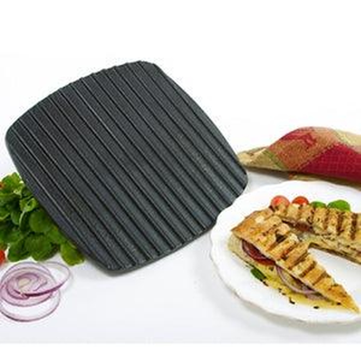 Norpro 963 cast iron panini press with ribbed grill surface shown alongside a grilled panini sandwich