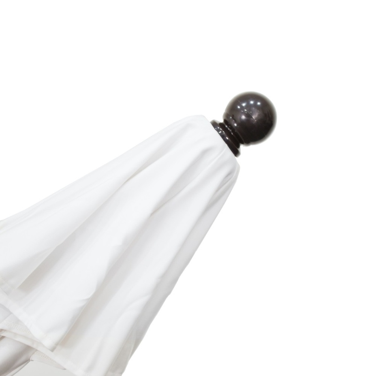 Close-up of the dark bronze ball finial at the top of the California Umbrella Venture Series with white canopy gathered below