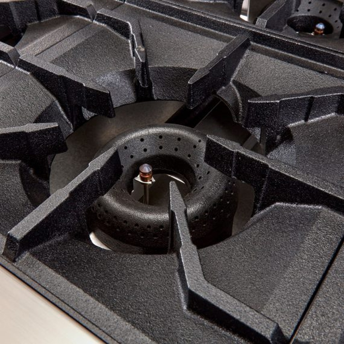 Close-up of American Range open burner and heavy-duty cast iron grate