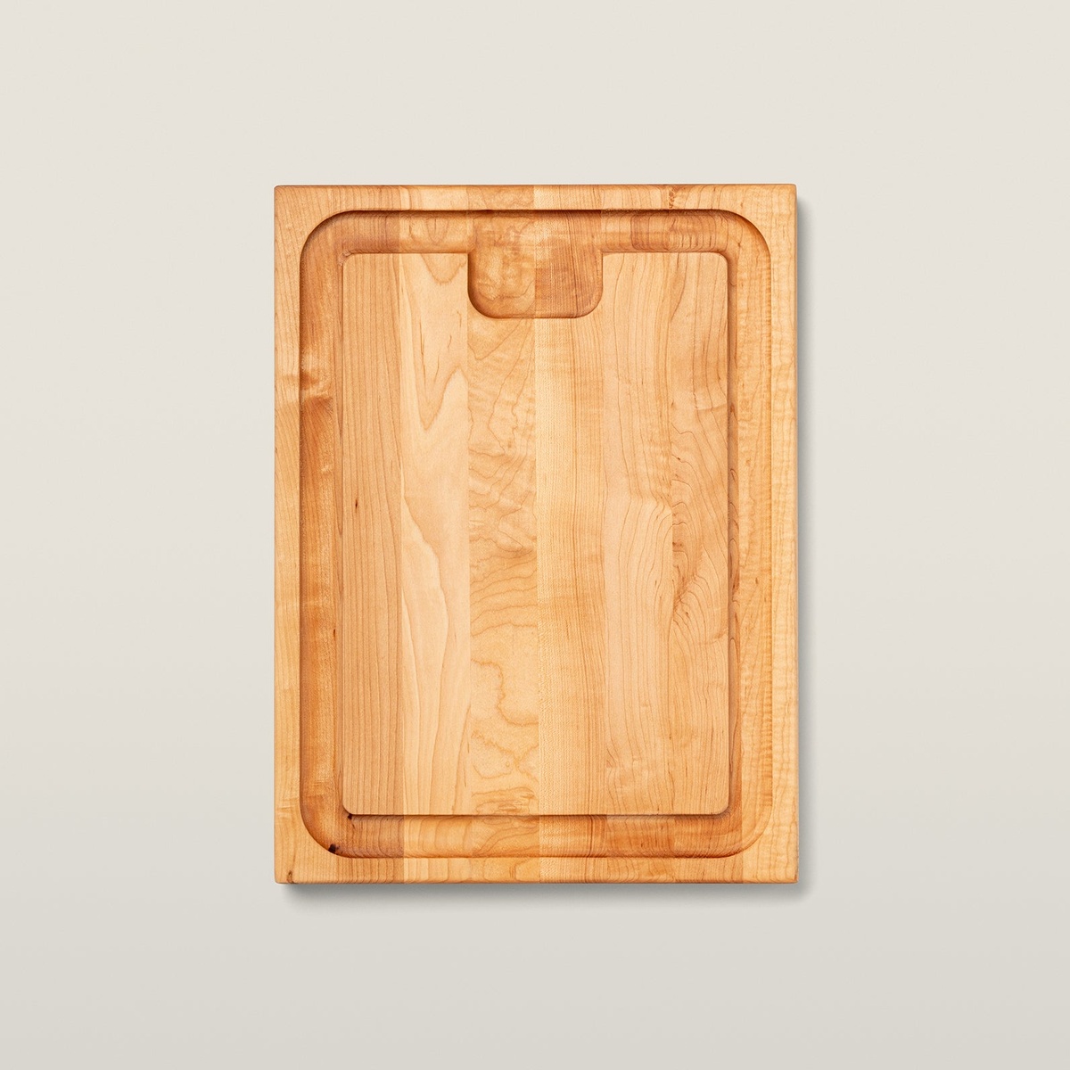 Top view of John Boos AuJus maple cutting board showing sloped juice groove and recessed finger grip