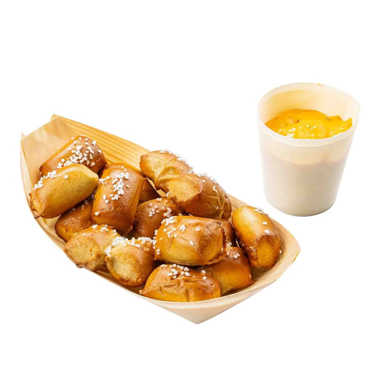 Disposable wood serving boat containing salted pretzel bites next to a dipping sauce cup