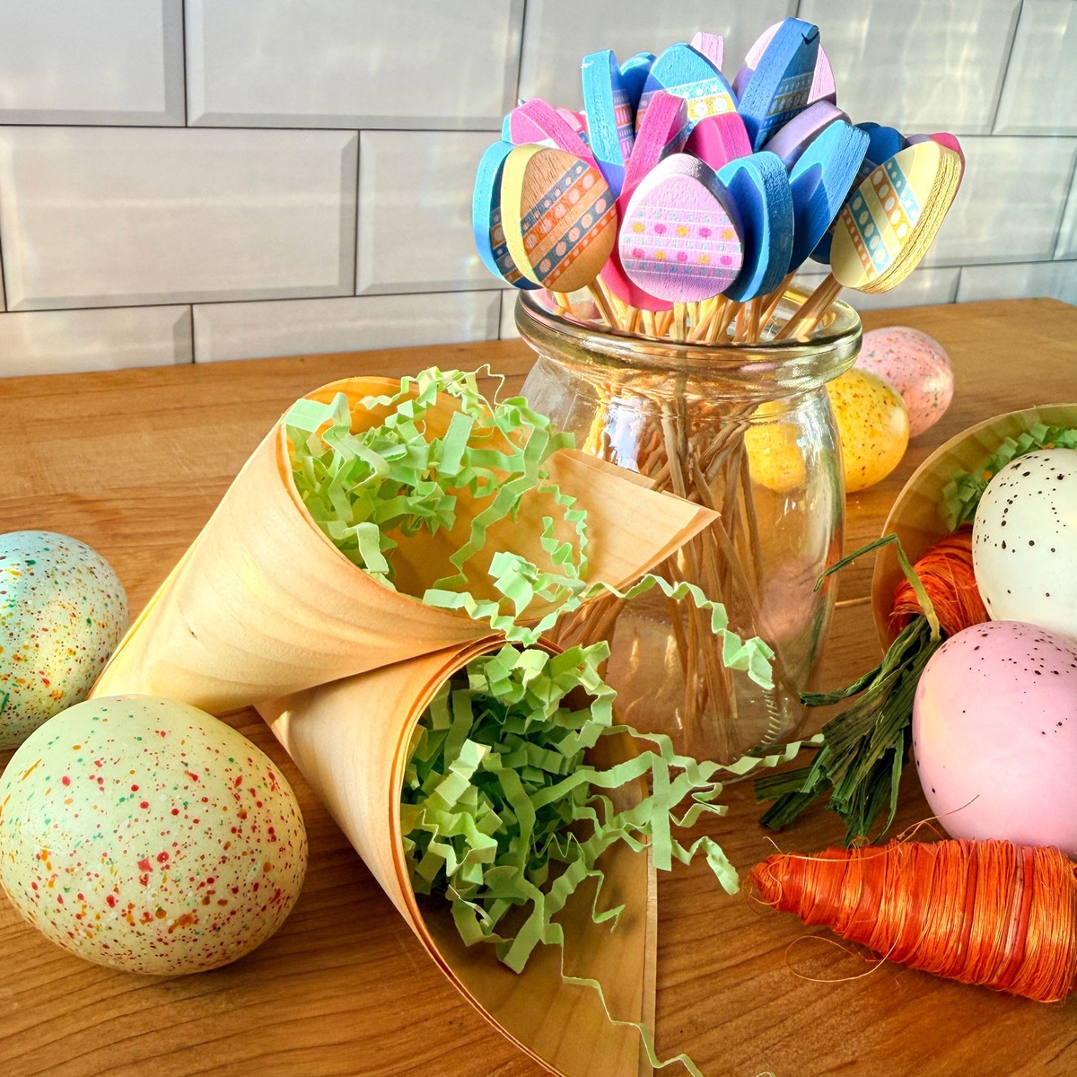 Creative Easter display using wooden cones as decorative holders for green filler and eggs