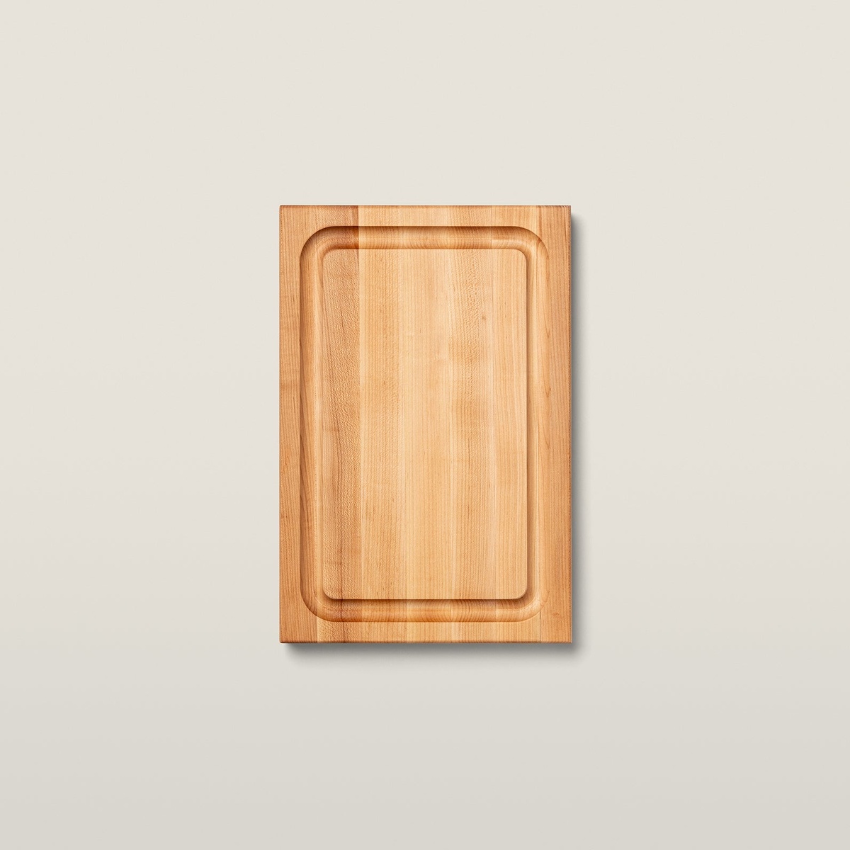Top-down view of the John Boos BBQBD maple cutting board showing the deep perimeter juice groove