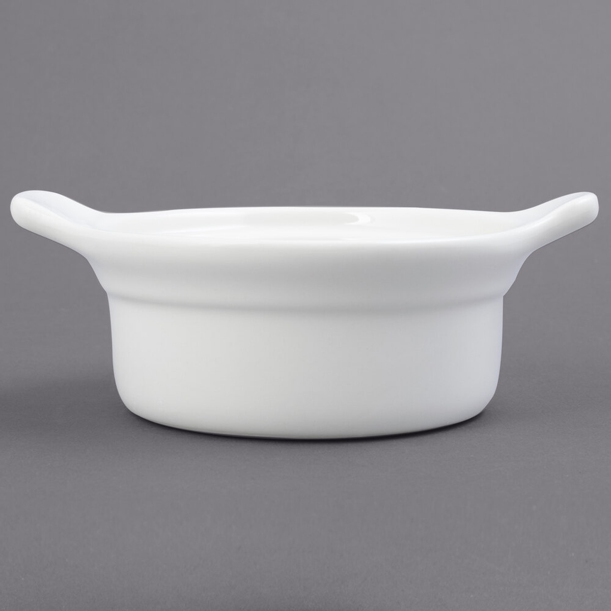 Tuxton BES-1004 eggshell white ceramic casserole dish with two lug handles, plain product view on gray background