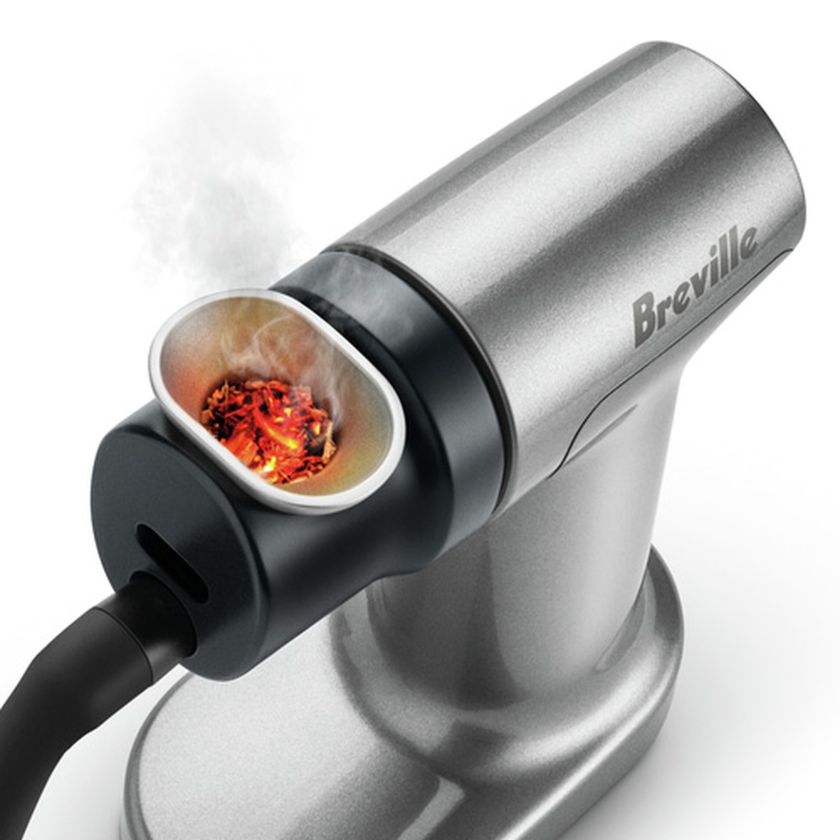 Close-up of a Breville smoking gun with wood chips glowing and producing smoke inside the combustion chamber