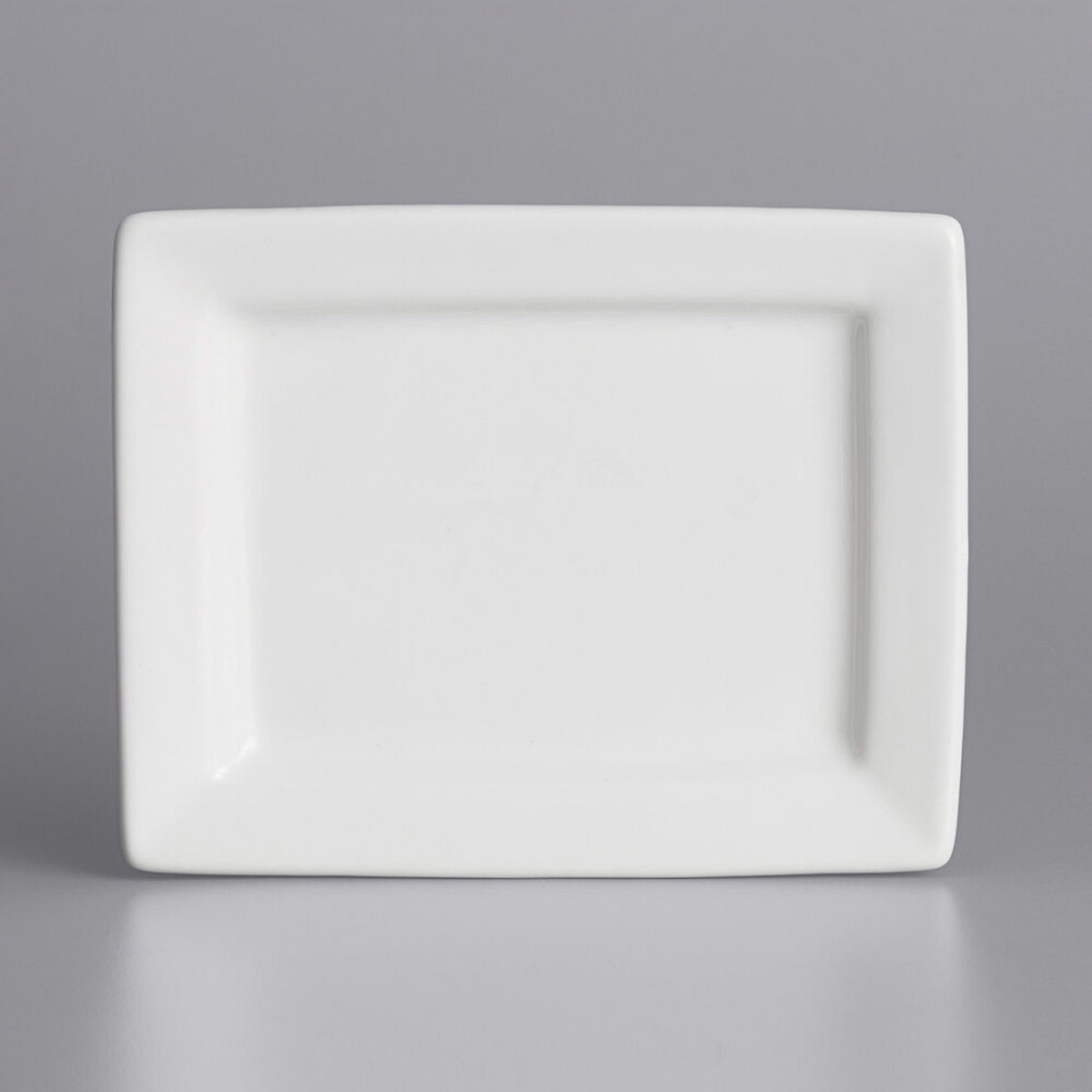 Tuxton BWH-0703 white rectangular china plate, angled side view showing profile and rim depth