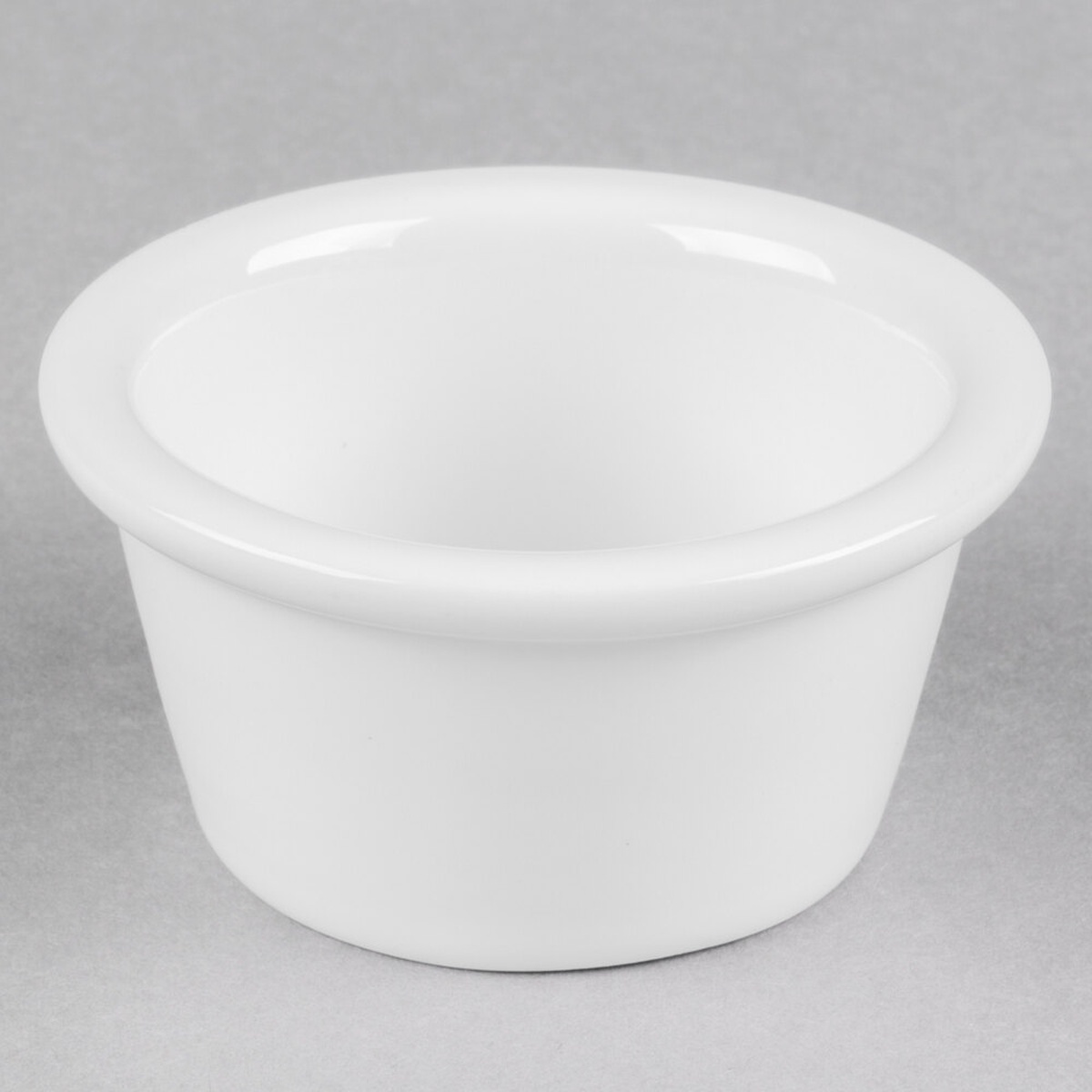 Tuxton BWX-020B 2 oz. white china ramekin with smooth tapered sides and defined upper lip