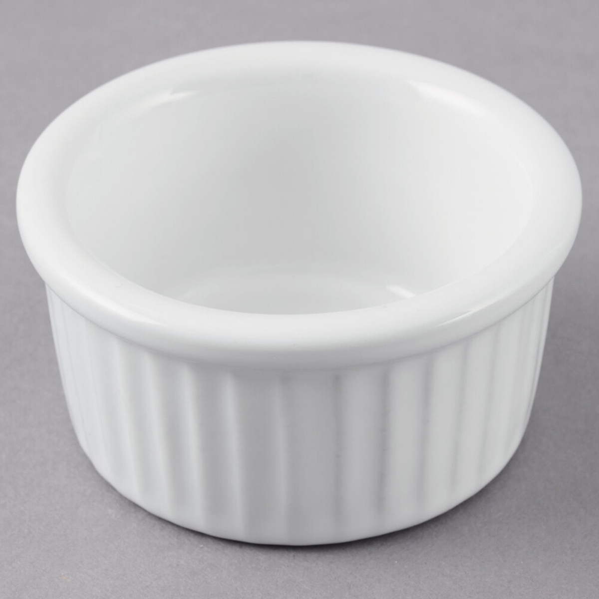 Tuxton BWX-0252 white fluted china ramekin, 2.5 oz., viewed from above at a slight angle