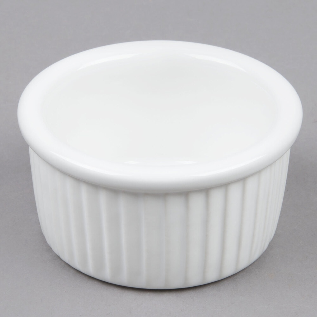 Tuxton BWX-0352 white fluted ceramic ramekin, 3.5 oz., shown from above at an angle