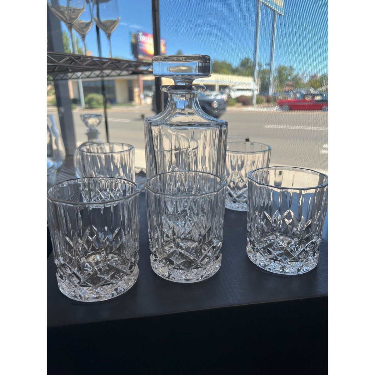 Full Enhanced Glassware set showing 30 oz decanter with stopper and six crystal-cut 7.5 oz rocks glasses arranged together