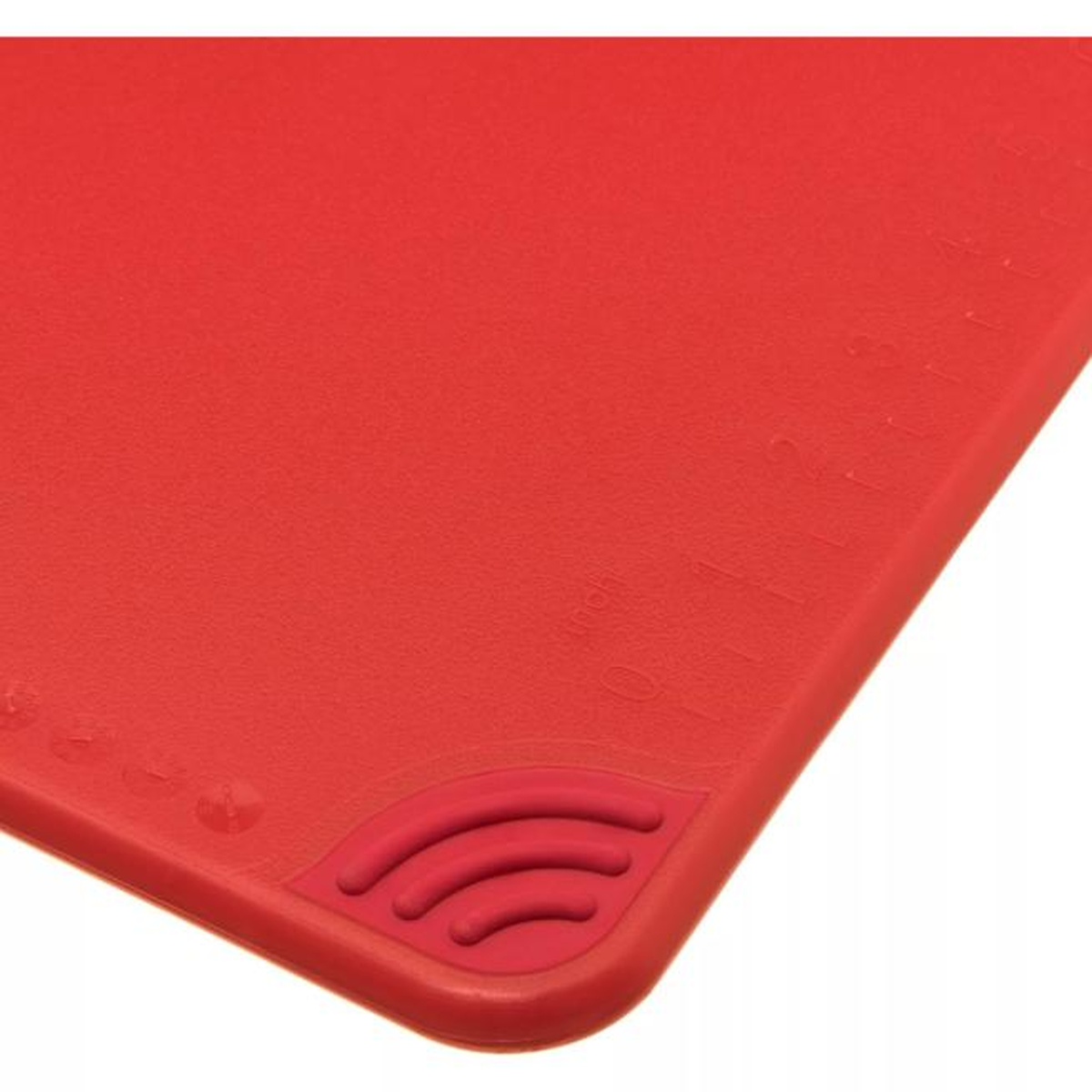 Close-up of anti-slip grip corner and ruler markings on the red San Jamar Saf-T-Grip cutting board