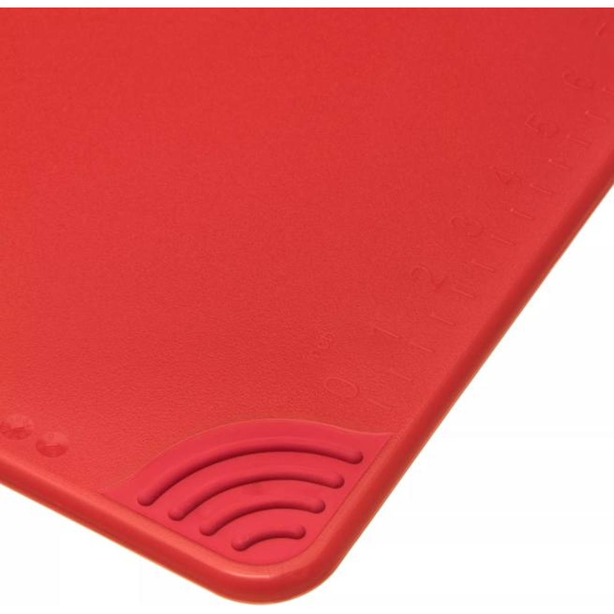 Close-up of the anti-slip grip corner and molded-in ruler markings on the San Jamar red cutting board