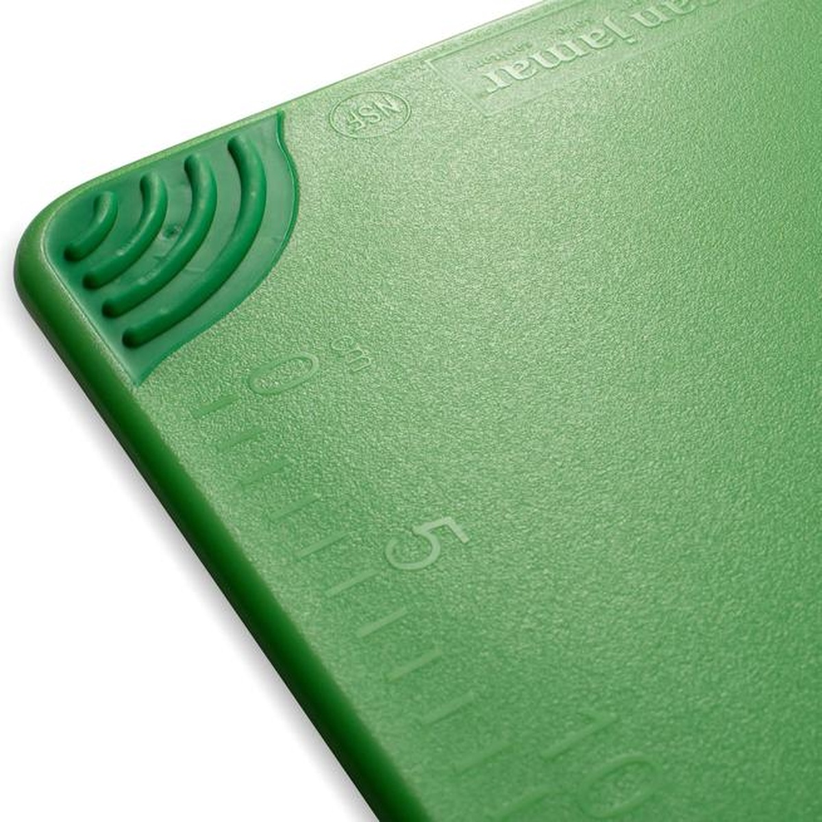 Close-up of San Jamar Saf-T-Grip cutting board corner showing anti-slip grip texture and molded-in ruler markings