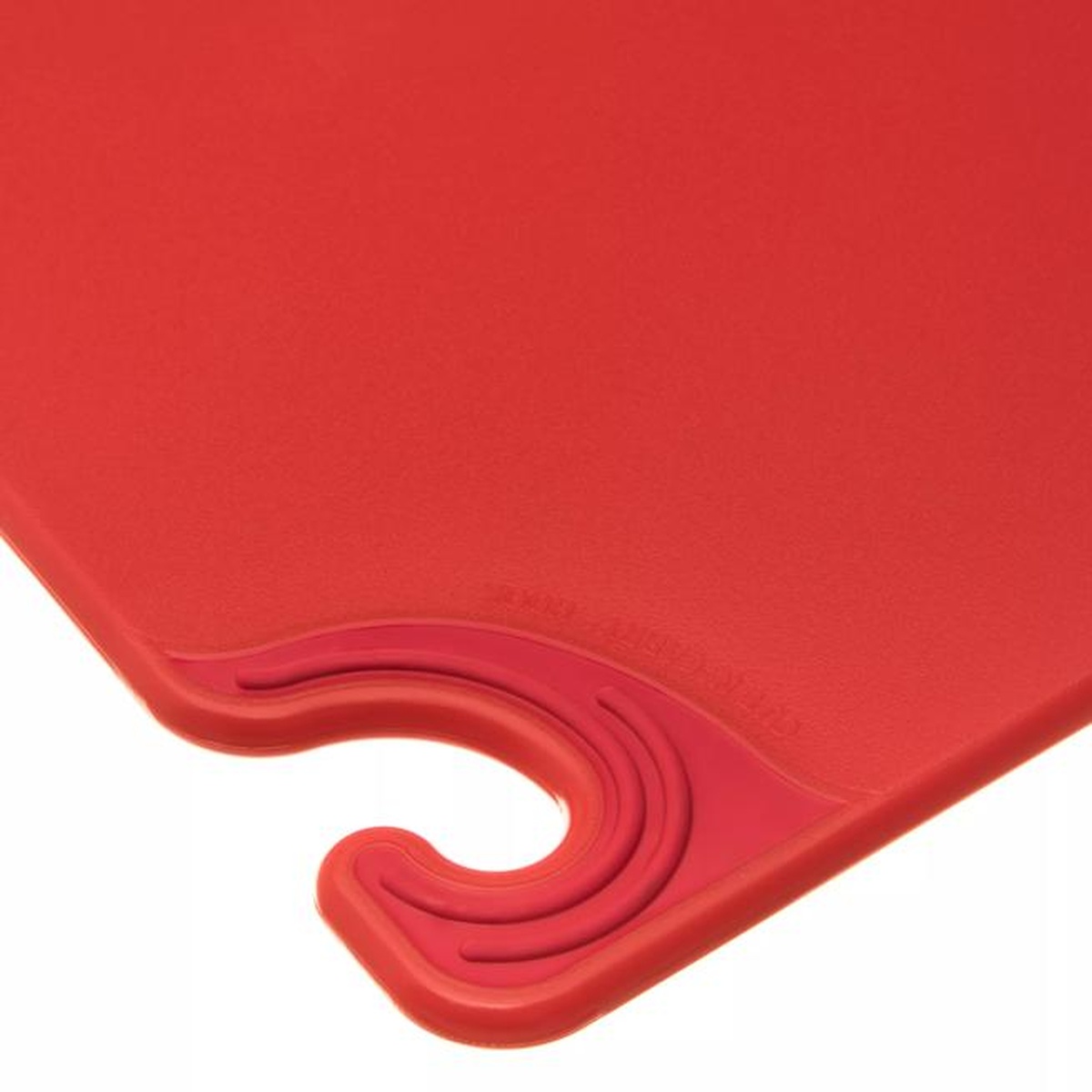 Close-up of red cutting board corner showing the food safety hook and anti-slip grip pad detail