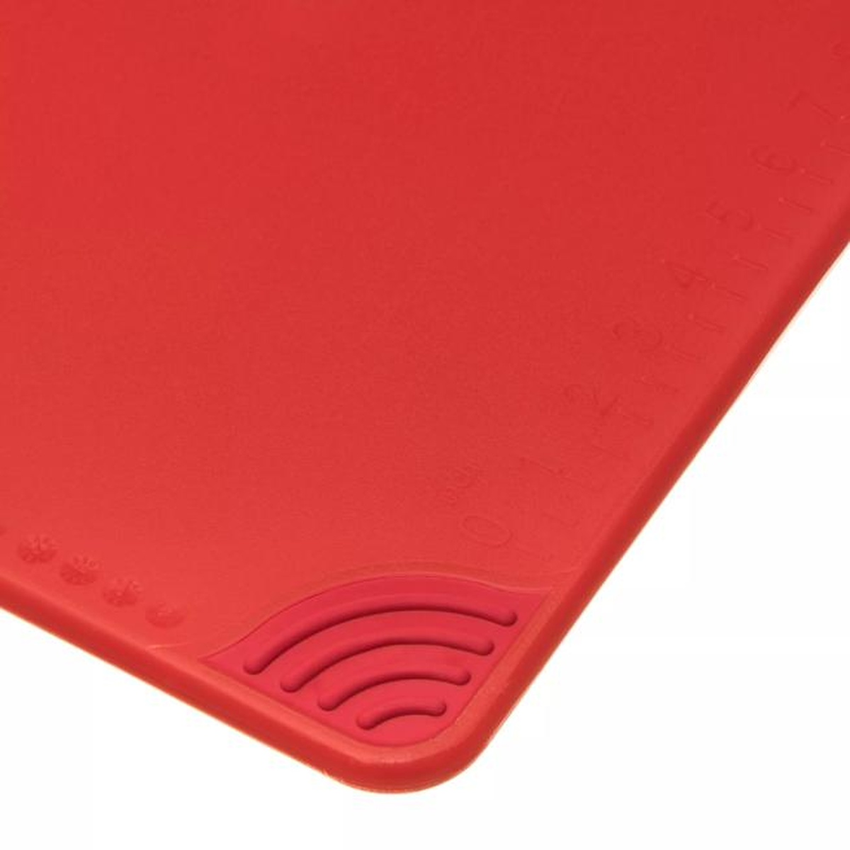 Close-up detail of molded anti-slip grip corner on red cutting board surface