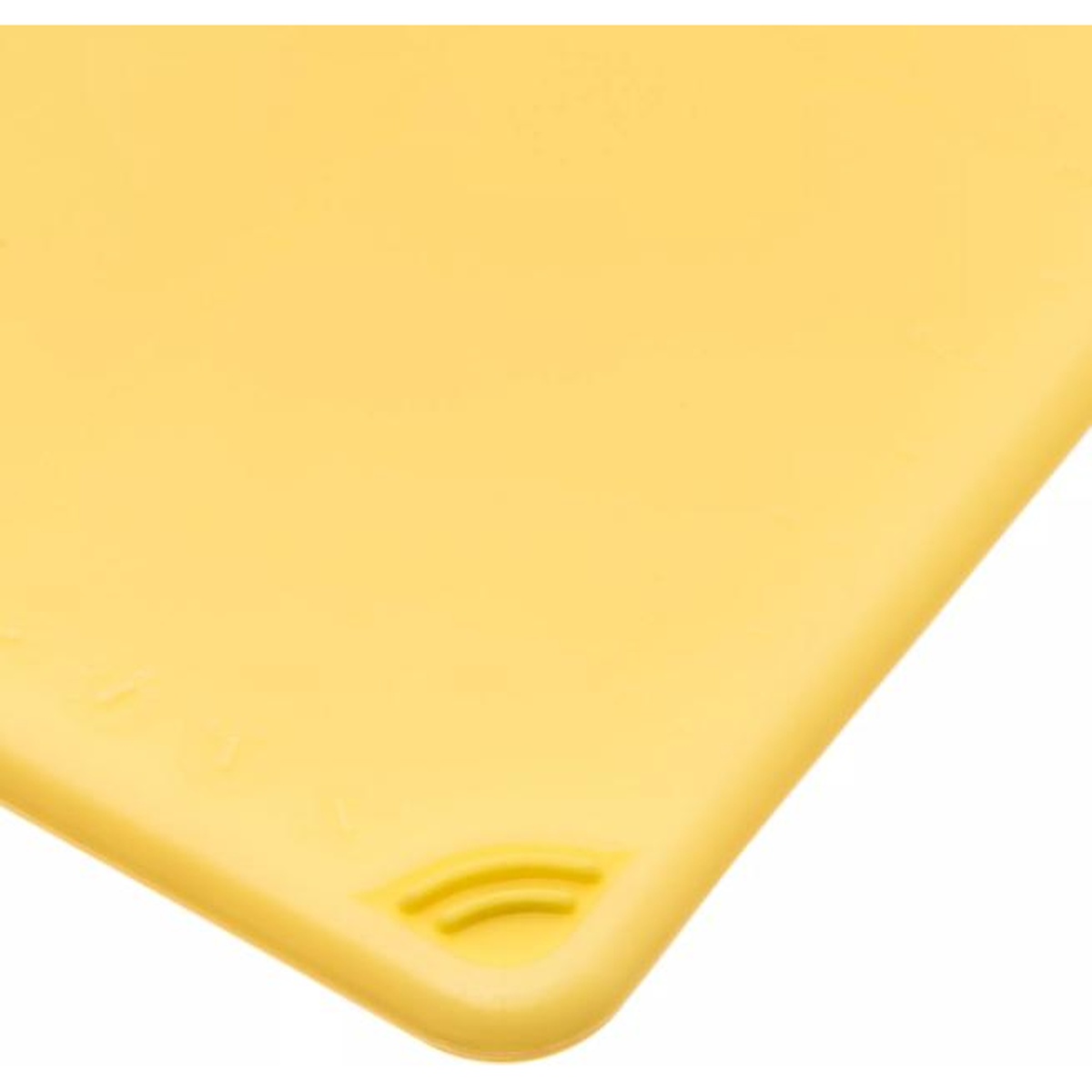 Close-up detail of the anti-slip grip corner on the yellow San Jamar Saf-T-Grip cutting board