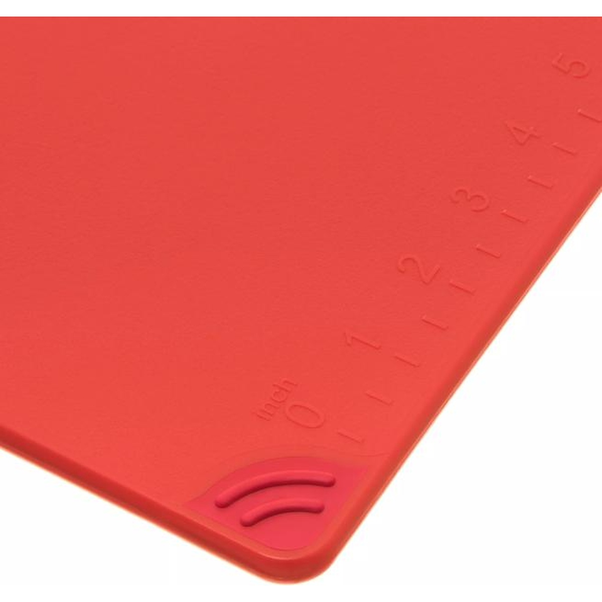 Close-up of the molded-in inch ruler on the corner of the red San Jamar cutting board