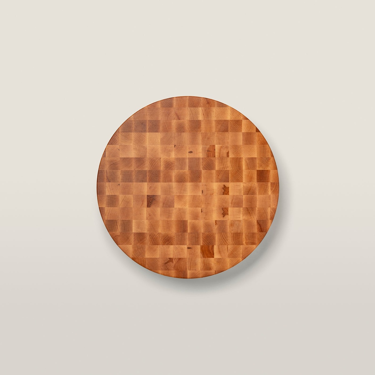 Top-down overhead view of a round John Boos end grain maple chopping block showing detailed wood grain and checkerboard pattern