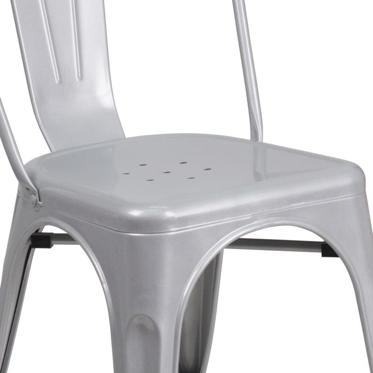 Close-up of silver metal chair seat showing drain holes and under-seat cross brace