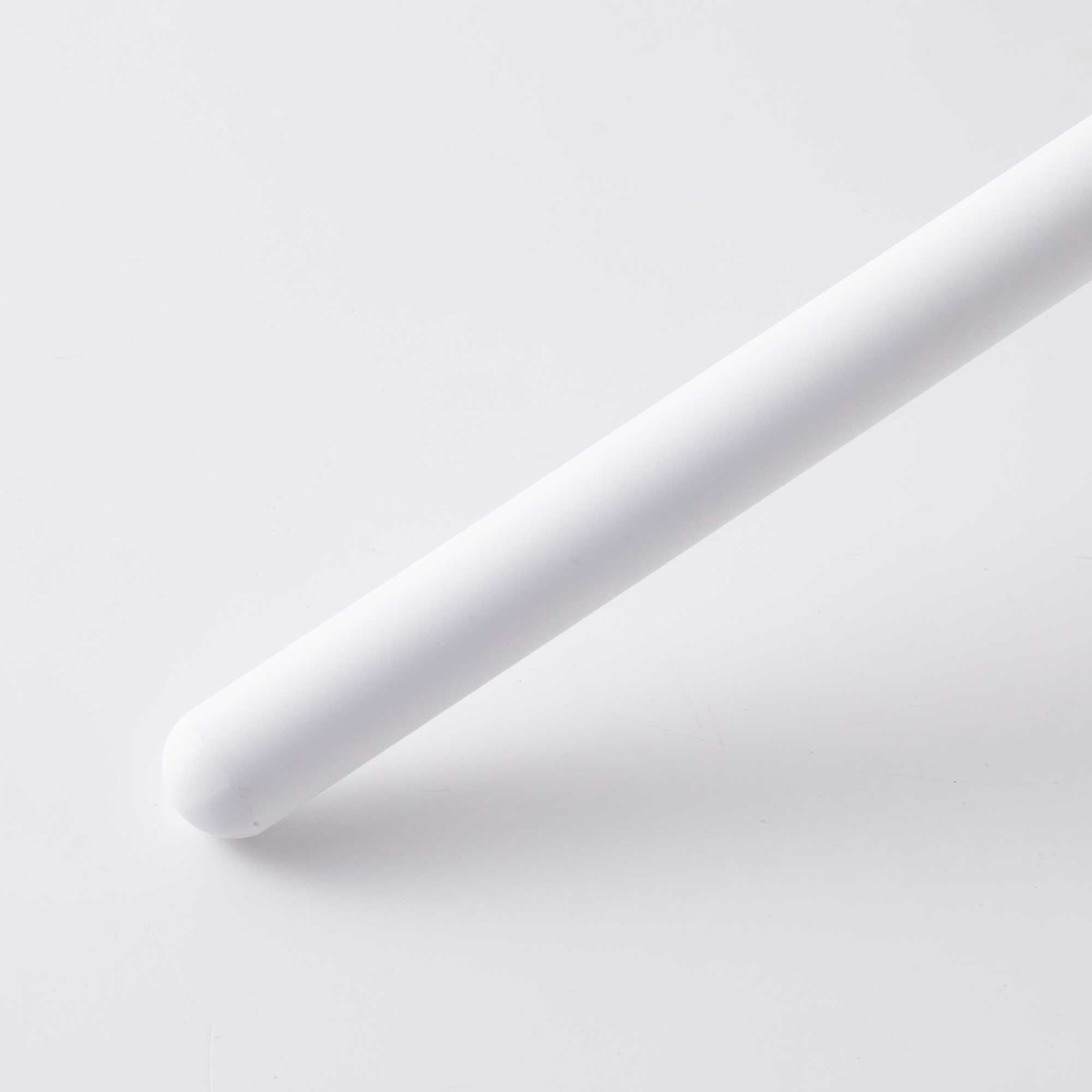 Close-up of the rounded white ceramic tip of the Messermeister sharpening rod showing smooth surface texture