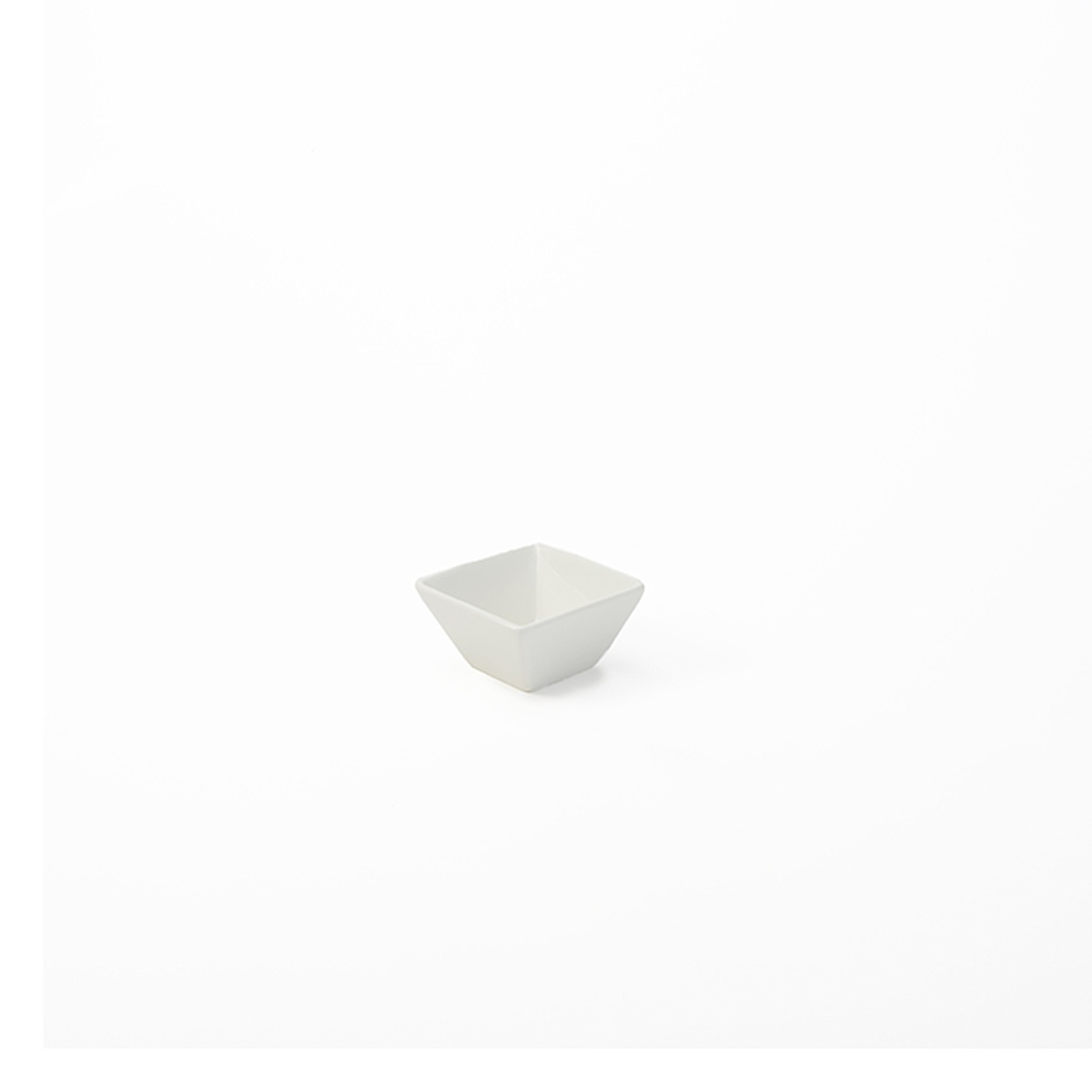 American Metalcraft CSC15 white square porcelain sauce cup, 1.5 oz, angled view showing smooth glossy finish and angular silhouette