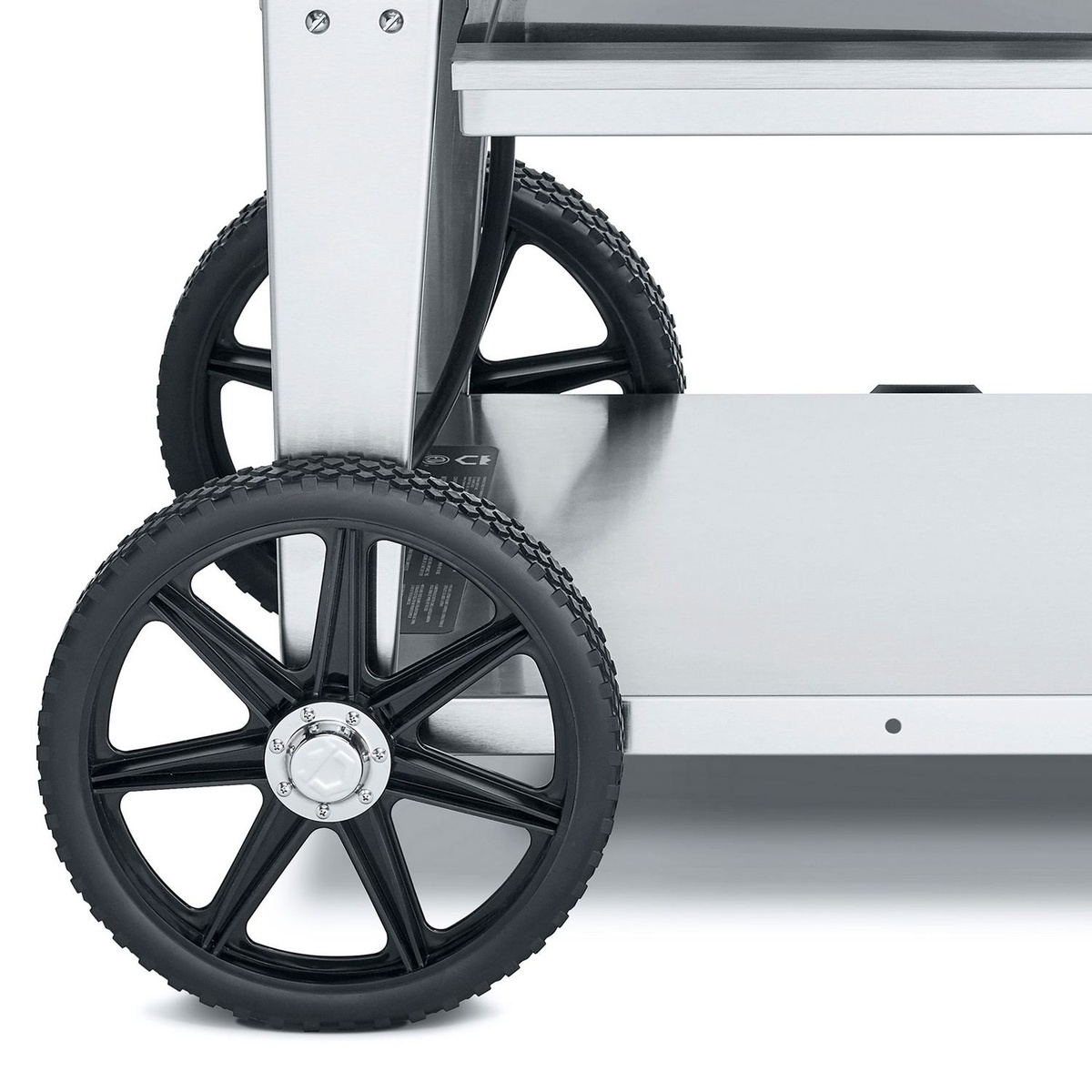 Close-up of the Crown Verity grill cart 14 inch wheel and lower stainless undershelf
