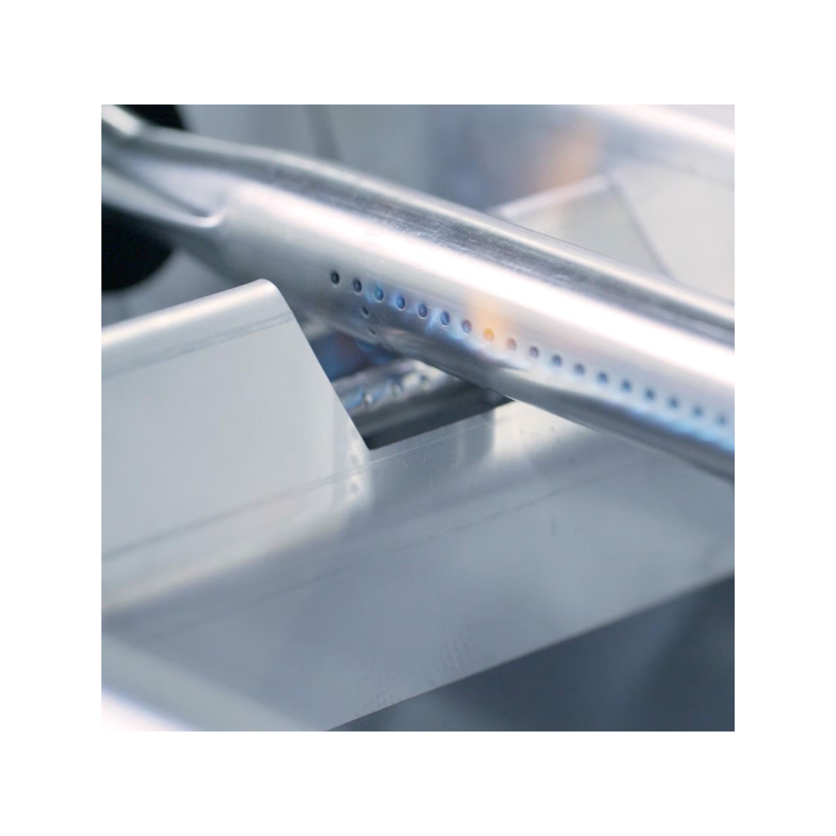 Close-up of stainless steel straight tube burner flame