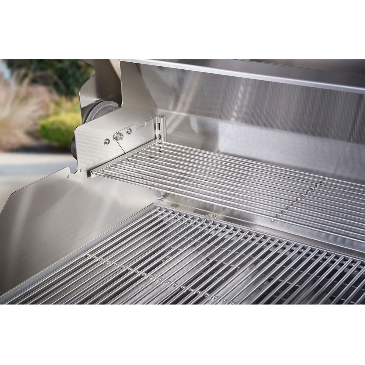 Stainless steel cooking grates and upper rack inside the grill