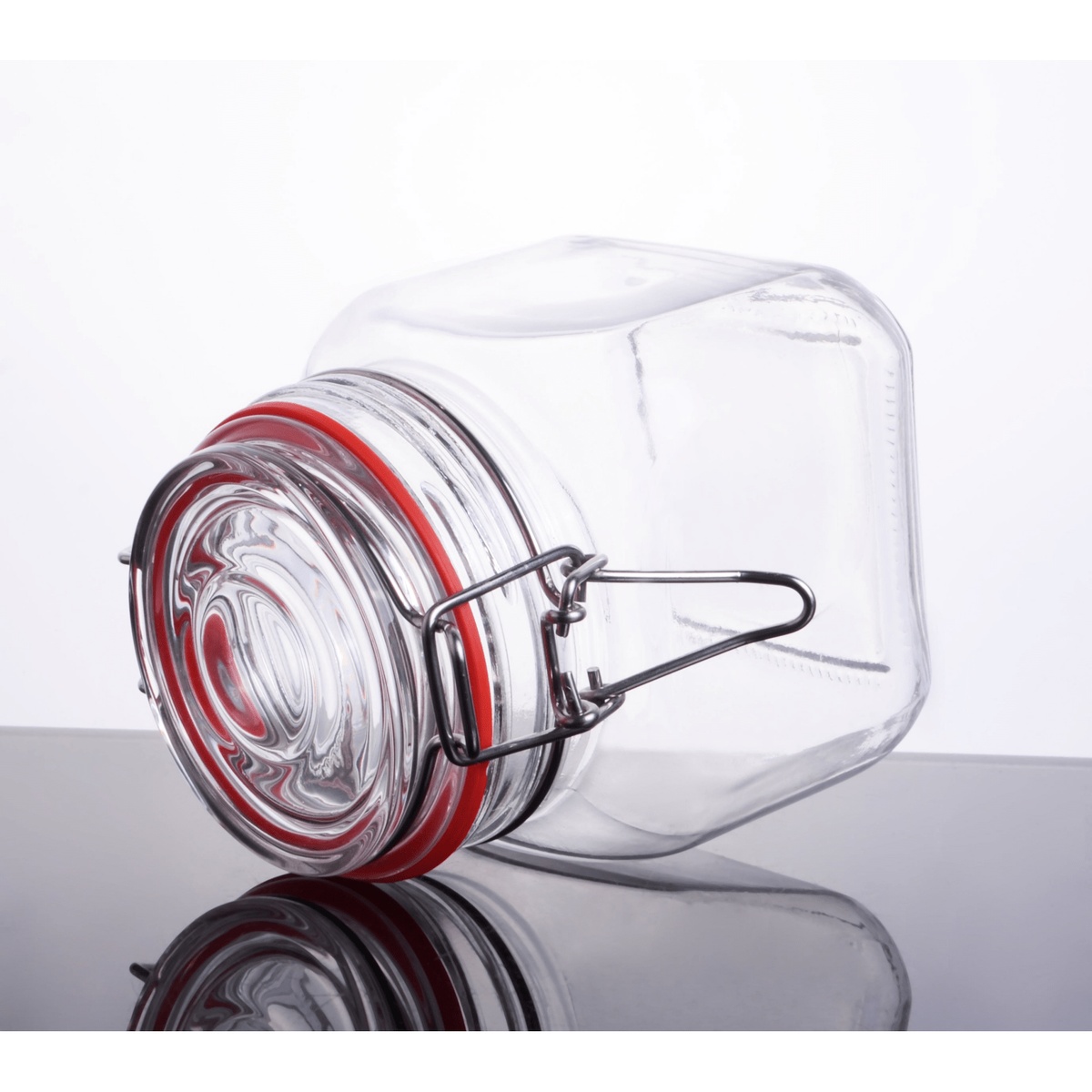 30 oz clear glass storage jar tipped on its side showing glass lid with red rubber seal ring and wire bail detail