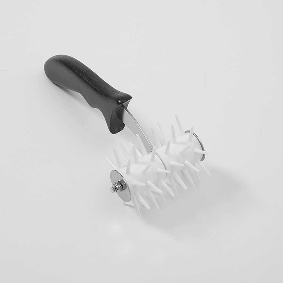 American Metalcraft DD5703 plastic roller dough docker with black ergonomic handle and white interlocking pin wheels on stainless steel axle