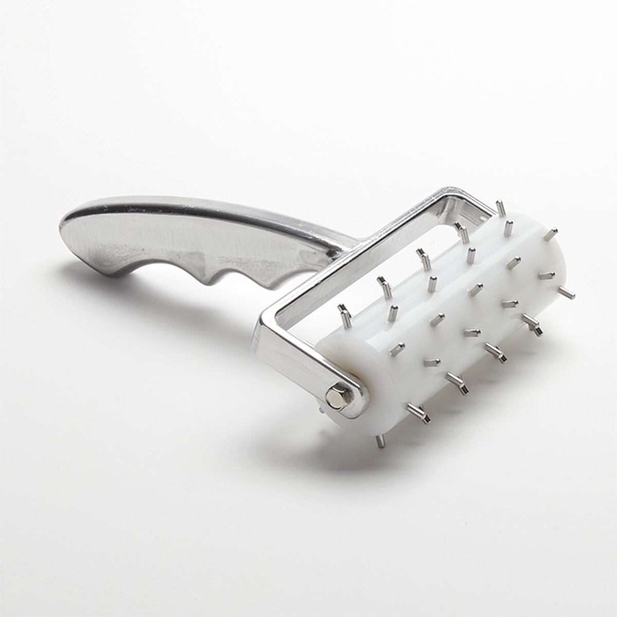 American Metalcraft DDCH7744 dough docker with cast aluminum handle and stainless steel pins on white plastic roller barrel